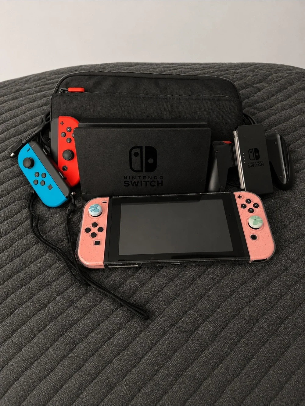 Nintendo Switch with Pink Joy‑Con Covers and Neon Blue/Red Controllers